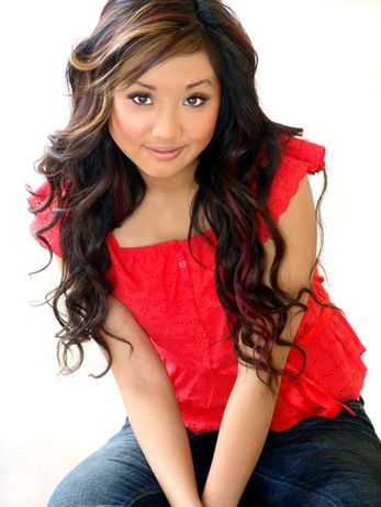 The red top and blue jeans look is good on Brenda Song